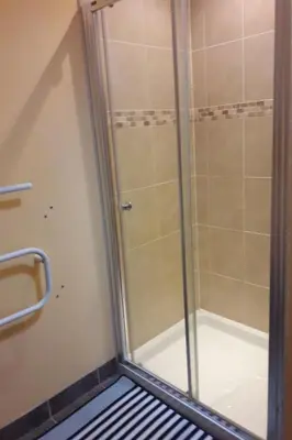 a shower with a glass door in a bathroom at Holiday Home Haus in Crickadarn mit Parkplatz und Bergblick by Interhome in Crickadarn