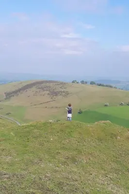 a person standing on a hill flying a kite at Holiday Home Haus in Crickadarn mit Parkplatz und Bergblick by Interhome in Crickadarn