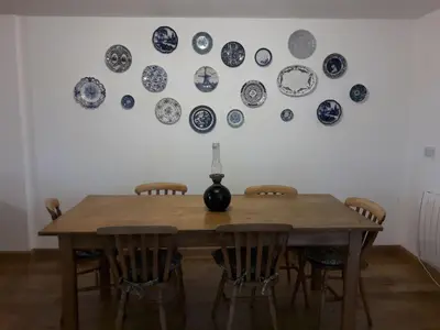 a dining room table with blue and white plates on the wall at Holiday Home Haus in Crickadarn mit Parkplatz und Bergblick by Interhome in Crickadarn