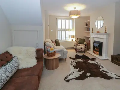 a living room with a couch and a fireplace at Cariad Cottage in Hereford