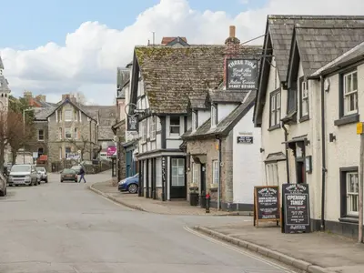 a street in a small town with buildings and cars at Cariad Cottage in Hereford
