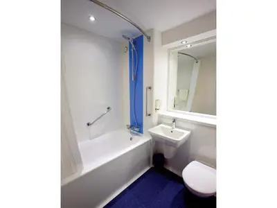a bathroom with a tub and a sink and a toilet at Travelodge Ludlow Woofferton in Brimfield