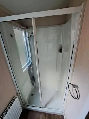 a shower with a glass door in a bathroom at Sea and Bay Viev Luxury Lodge in Clarach bay in Aberystwyth