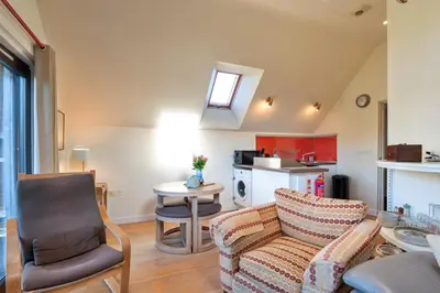 a living room with a couch and a chair at Finest Retreats - Canal Central in Ball