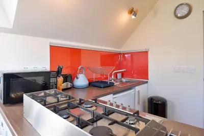 a kitchen with a stove top oven next to a sink at Finest Retreats - Canal Central in Ball