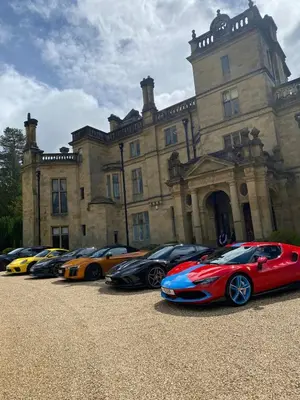 a row of expensive cars parked in front of a building at Pont Wrysgen Cottage 'the gateway to Snowdonia' in Mallwyd