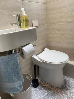 a bathroom with a white toilet and a sink at Pont Wrysgen Cottage 'the gateway to Snowdonia' in Mallwyd