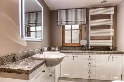 a white bathroom with a sink and a mirror at Long Barn in Ludlow