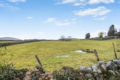 a field with a fence in front of a field at 2 Bed in Trawsfynydd oc-t34148 in Trawsfynydd