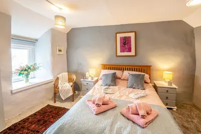 a bedroom with a large bed with two pink pillows at 2 Bed in Trawsfynydd oc-t34148 in Trawsfynydd