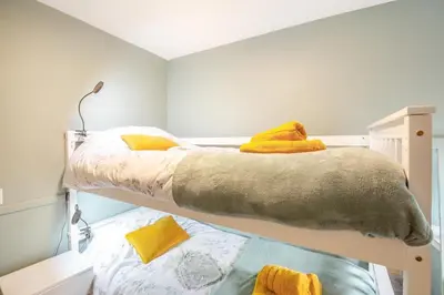 a bedroom with two bunk beds with yellow pillows at 2 Bed in Trawsfynydd oc-t34148 in Trawsfynydd