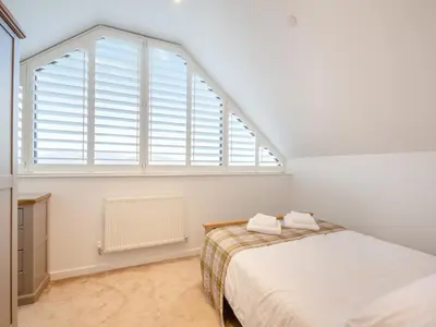 a bedroom with a bed and a large window at Arenig View - Uk51068 in Frongoch