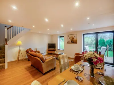a living room with a table and a couch at The Aran - Uk51067 in Frongoch