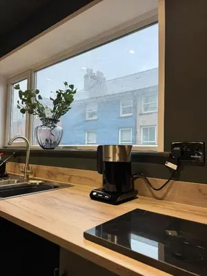 a coffee maker sitting on a counter next to a window at The Resting Place in Aberystwyth
