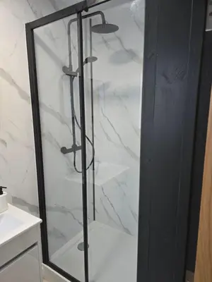 a shower with a glass door in a bathroom at The Resting Place in Aberystwyth