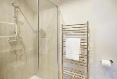 a bathroom with a shower and a glass shower stall at Orchard Farm in Ludlow