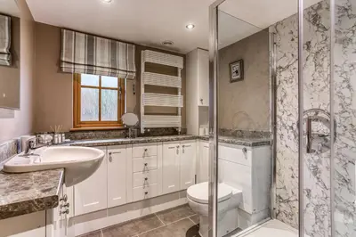 a bathroom with a toilet and a sink and a shower at Orchard Farm in Ludlow