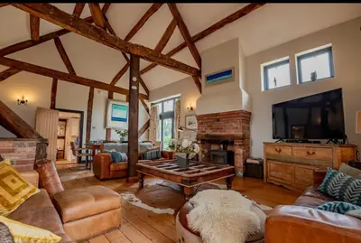 a living room filled with furniture and a fireplace at 5 bedroom Barn, Ludlow in Caynham