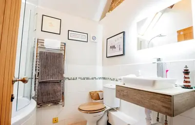 a white bathroom with a sink and a toilet at 5 bedroom Barn, Ludlow in Caynham