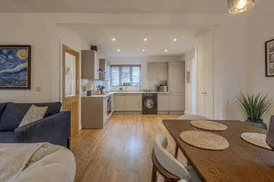 a living room with a dining table and a kitchen at Judith House in Shrewsbury