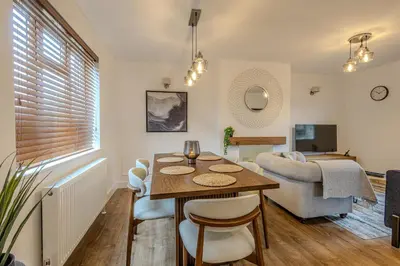 a living room with a table and a couch at Judith House in Shrewsbury