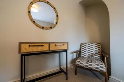a dressing table with a mirror and a chair at Fantastic 6-bedroom house close to Shrewsbury town - Pass the Keys in Shrewsbury