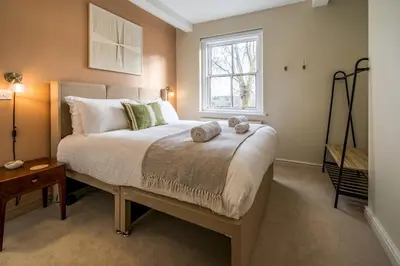a bedroom with a bed with two towels on it at Fantastic 6-bedroom house close to Shrewsbury town - Pass the Keys in Shrewsbury