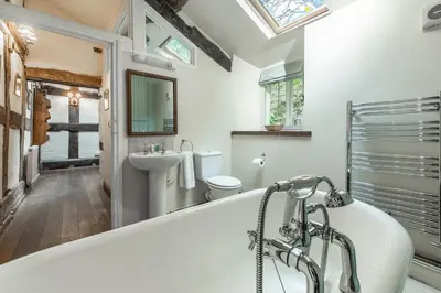 a bathroom with a tub and a toilet and a sink at Tanat Valley Farmhouse in Hirnant