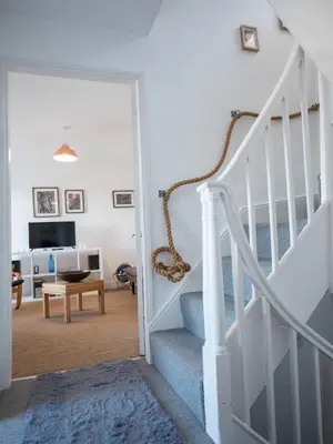 a living room with a staircase and a living room at Harbour View in Aberaeron