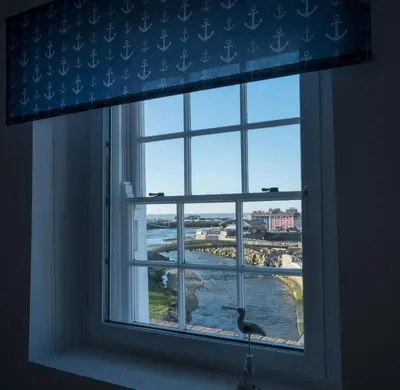 a window with a bird sitting in a window sill at Harbour View in Aberaeron