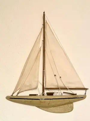 a wooden sail boat hanging on a wall at Harbour View in Aberaeron