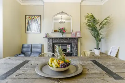 a bowl of fruit on a wooden table with a fireplace at 5 Bed in Llangollen oc-l34205 in Llangollen