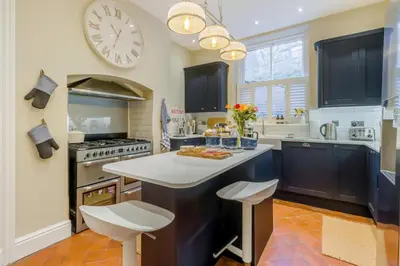 a kitchen with a large clock on the wall at 5 Bed in Llangollen oc-l34205 in Llangollen