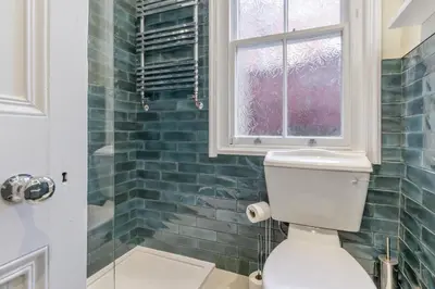 a bathroom with a toilet and a window and a shower at 5 Bed in Llangollen oc-l34205 in Llangollen