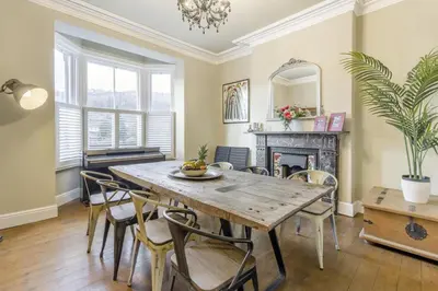 a dining room with a table and chairs and a fireplace at 5 Bed in Llangollen oc-l34205 in Llangollen