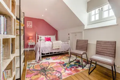 a bedroom with a bed and two chairs at 5 Bed in Llangollen oc-l34205 in Llangollen