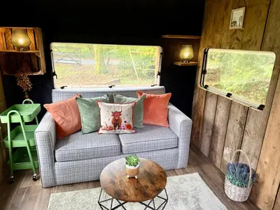 a living room with a couch and a table at Nesta's Nook in Llandovery