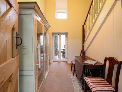 a hallway with a table and a dining room at Bryn Y Garreg Cottage - The Wireless Tech Free Farm in Llangadfan