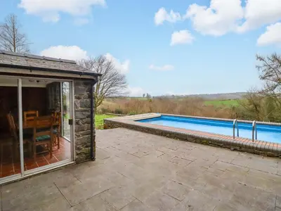 an external view of a house with a swimming pool at Bryn Y Garreg Cottage - The Wireless Tech Free Farm in Llangadfan