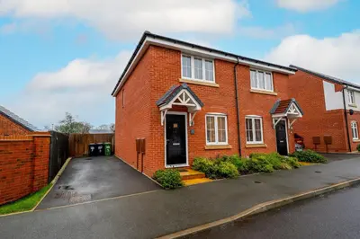 a red brick house with a driveway at Cosy & Contemporary 2 Bed Home, Quiet Area Parking - Pass the Keys in Shrewsbury