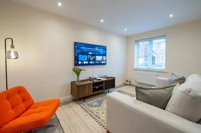 a living room with a couch and a tv at Cosy & Contemporary 2 Bed Home, Quiet Area Parking - Pass the Keys in Shrewsbury
