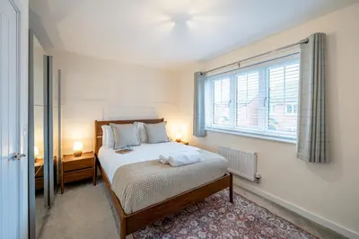 a bedroom with a bed and a large window at Cosy & Contemporary 2 Bed Home, Quiet Area Parking - Pass the Keys in Shrewsbury