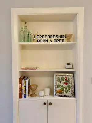 a book shelf with books and a sign on it at Unique Vicarage Town Cottage in Leominster