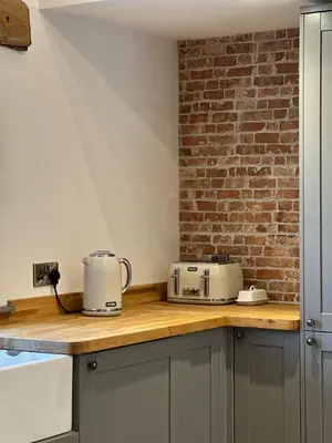 a kitchen with two toasters on a counter at Y Beudy Bach in Llanfor