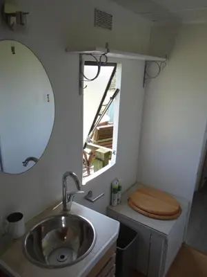 a bathroom with a sink and a toilet with a mirror at Canad Adar - Song of the Birds - Teifi Valley in Llanwenog