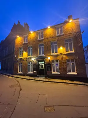 a large brick building on a street at night at Cosy Town centre Historic Tudor Cottage & parking sleeps 6 in Shrewsbury