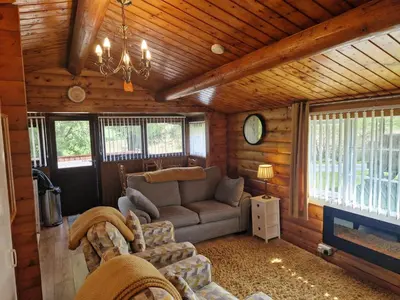 a living room with a couch in a cabin at Cabin Retreat in Trawsfynydd
