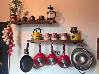a bunch of pots and pans hanging on a wall at Cosy, quirky Victorian house on Waterfall Street in Llanrhaeadr-ym-Mochnant