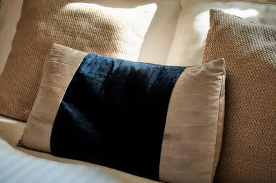 a black and brown pillow on a couch at Ever popular 2 bedroom riverside home - to sleep 4 - Pass the Keys in Shrewsbury