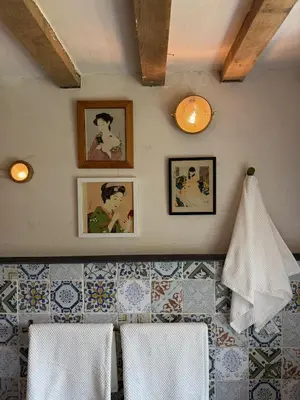 a kitchen with white towels and pictures on the wall at Y Beudy - A Converted Barn in the Brecon Beacons in Brecon